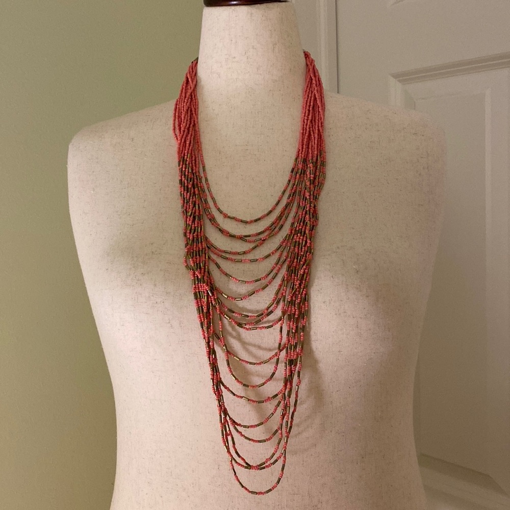 Long NWOT necklace with 18 strands of coral antique gold beads
